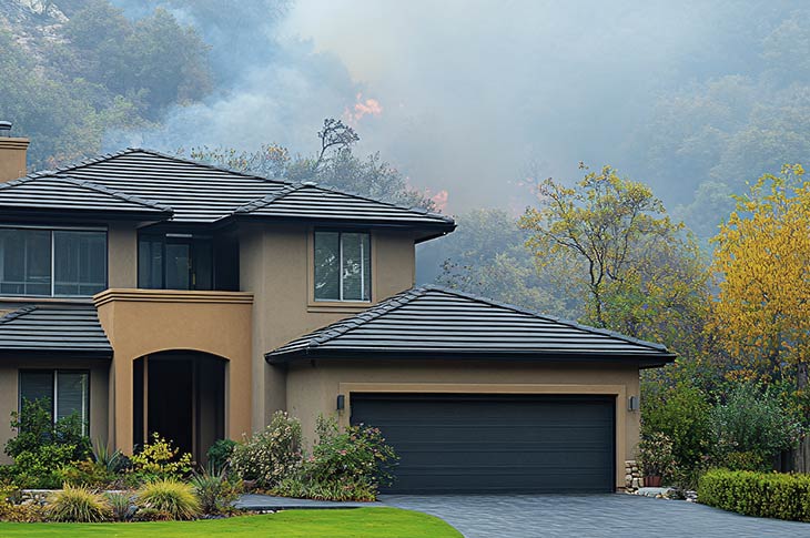 A house with fireproof roofing and walls built with sustainable materials to withstand wildfires.