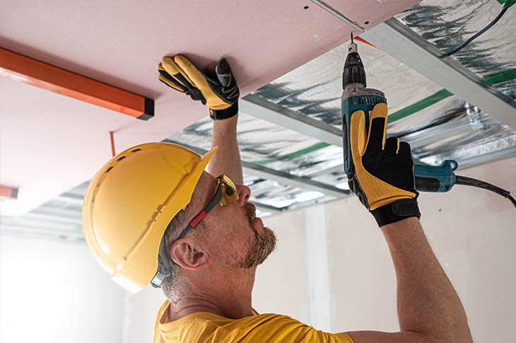 Contractor installing fire-resistant drywall to improve home safety and enhance Pacific Palisades home fireproofing.